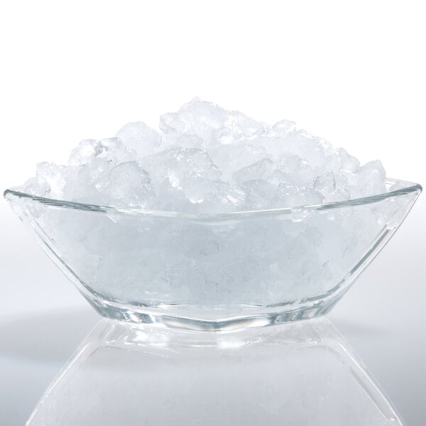 A clear glass with flake ice on a white background.