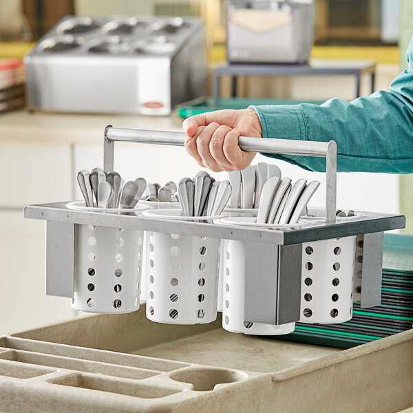 A person using a Steril-Sil drop-in flatware basket to hold silverware.