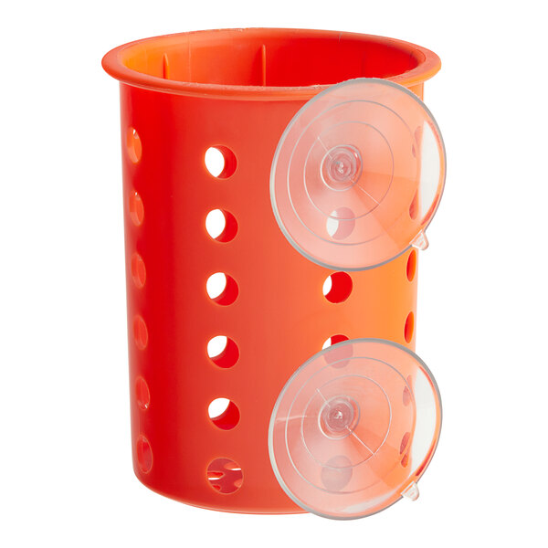 An orange plastic flatware cylinder with holes and suction cups.