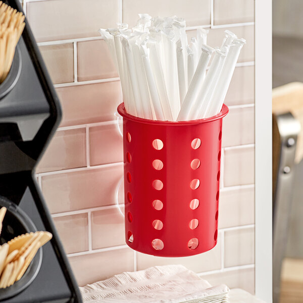 A red Steril-Sil flatware container with holes.