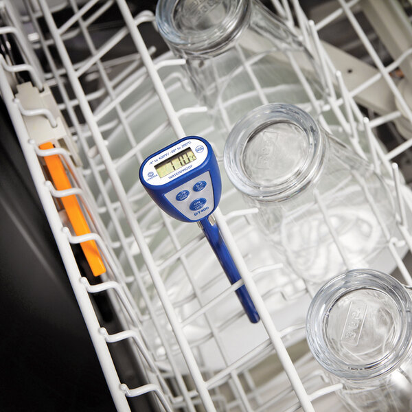 A Comark blue digital pocket probe thermometer in a dishwasher.