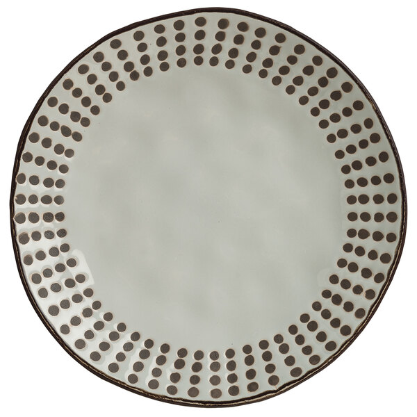 A white plate with brown dots on it.