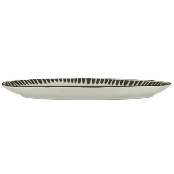 A white stoneware platter with black lines.