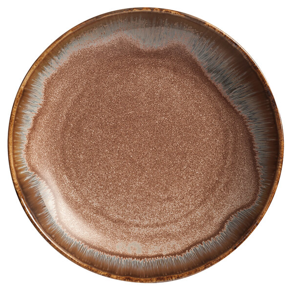 A white porcelain coupe bowl with a brown speckled rim.