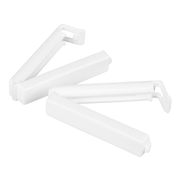 Two white plastic clips with hinged ends, shown in an open position on a white background.