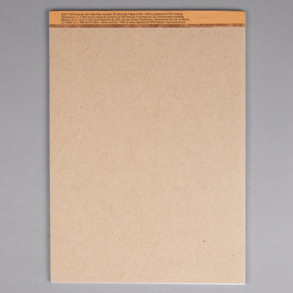 A white legal pad with yellow tape on it.