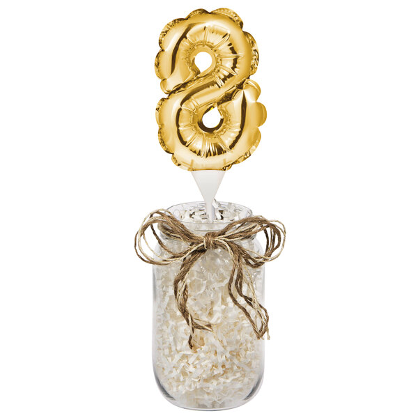A jar with a gold foil number 8 balloon in it.
