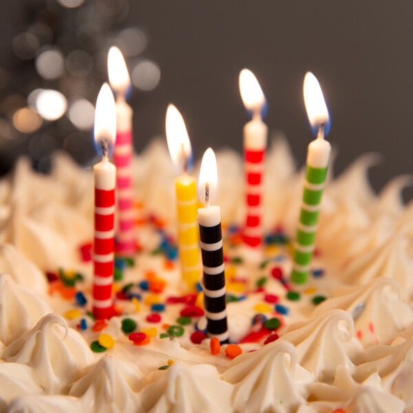 A cake with Creative Converting striped candles on top.