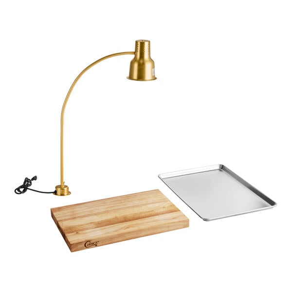 A carving station kit with a gold heat lamp, a wooden cutting board, and a metal drip pan.