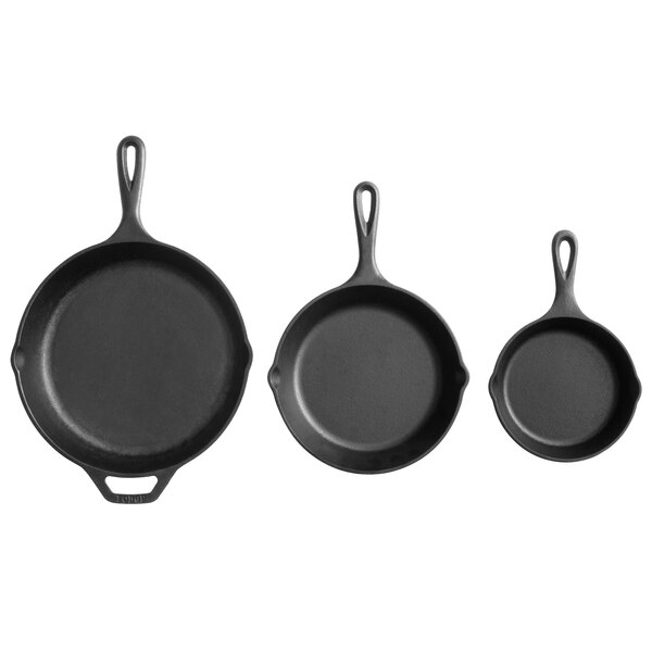A group of three Lodge pre-seasoned cast iron skillets with handles.