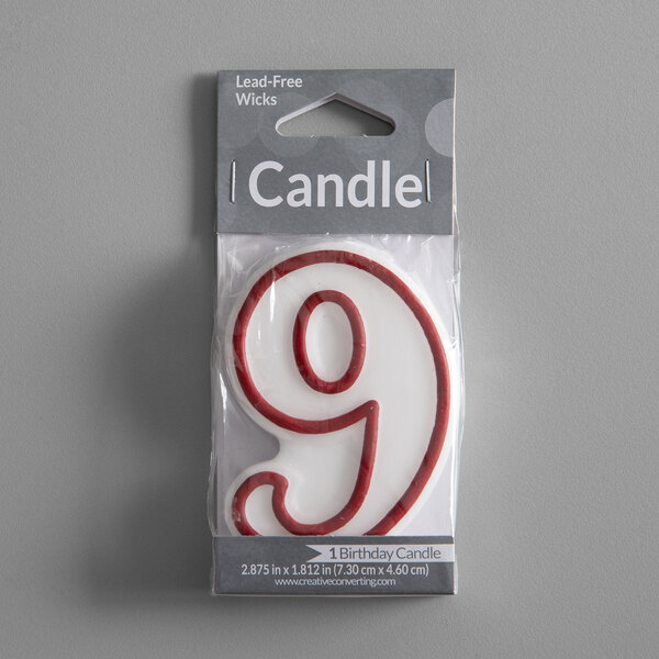 A white candle outlined in red with the number "9" in a plastic wrap package.