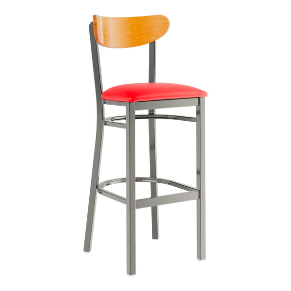 A Lancaster Table & Seating bar stool with a red vinyl seat and cherry wood back and metal frame.