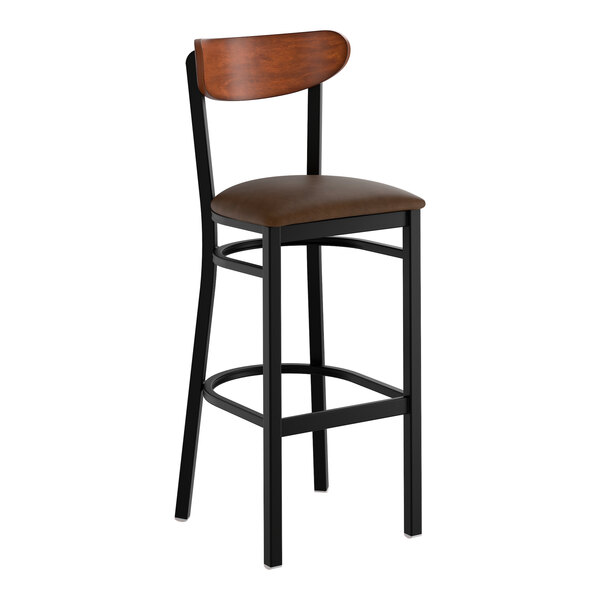 A black metal bar stool with a dark brown vinyl seat and an antique walnut wood backrest.
