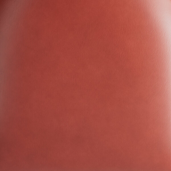 A burgundy vinyl seat of a chair with a smooth texture.