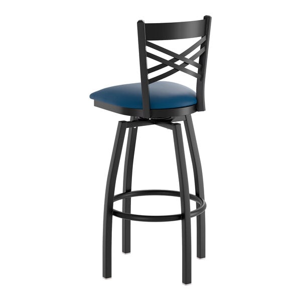 A black metal bar stool with a cross back design and a navy blue padded vinyl seat.
