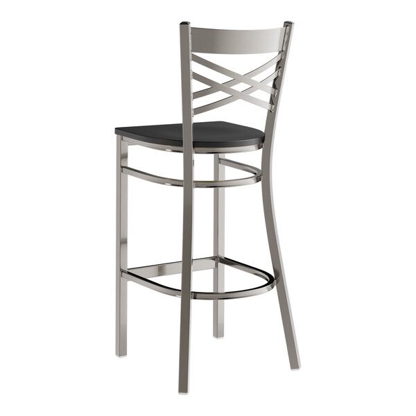 A metal bar stool with a cross back design and a black wood seat.