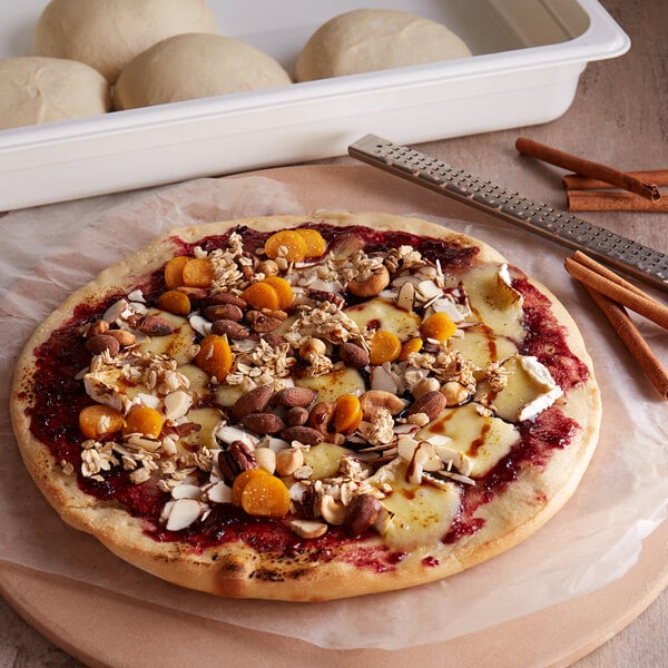 A table with a pizza made with DeIorio's frozen bread dough, nuts, and jam on it.