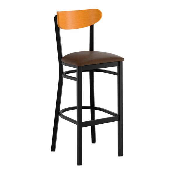 A black metal bar stool with a dark brown vinyl seat and a cherry wood backrest.