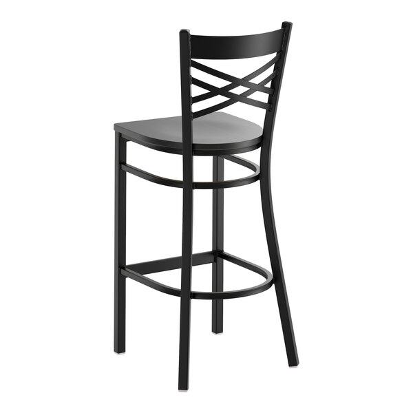 A black metal bar stool with a cross back design and a black wood seat.