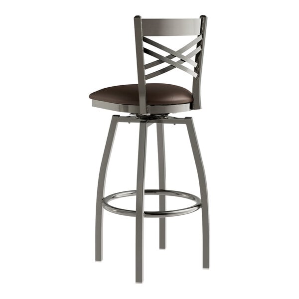 A Lancaster Table & Seating metal swivel bar stool with a dark brown vinyl seat.