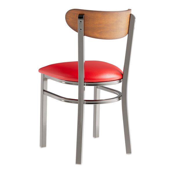 A Lancaster Table & Seating Boomerang chair with a red vinyl cushion.
