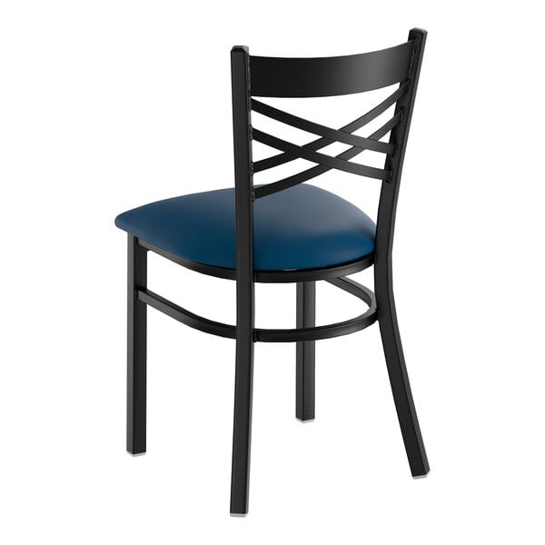 A black metal chair with a cross back design and a navy blue padded vinyl seat.