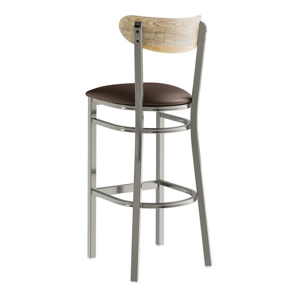 A Lancaster Table & Seating bar stool with a dark brown vinyl seat and driftwood back.