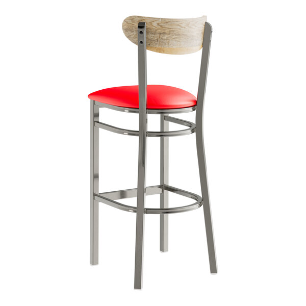 A Lancaster Table & Seating bar stool with a red vinyl seat and driftwood back.