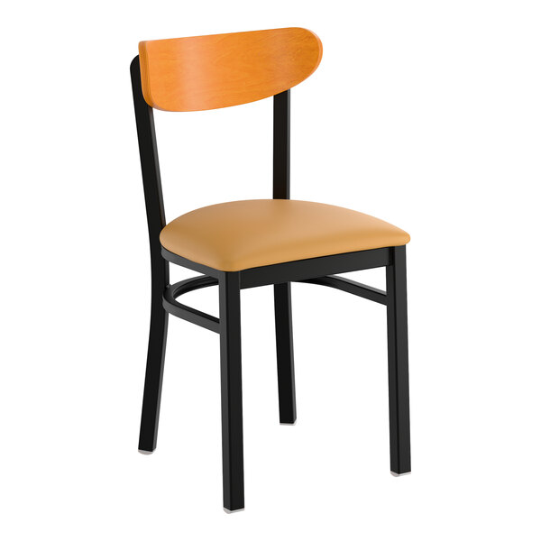 A black metal chair with a light brown vinyl seat and a cherry wood curved backrest.