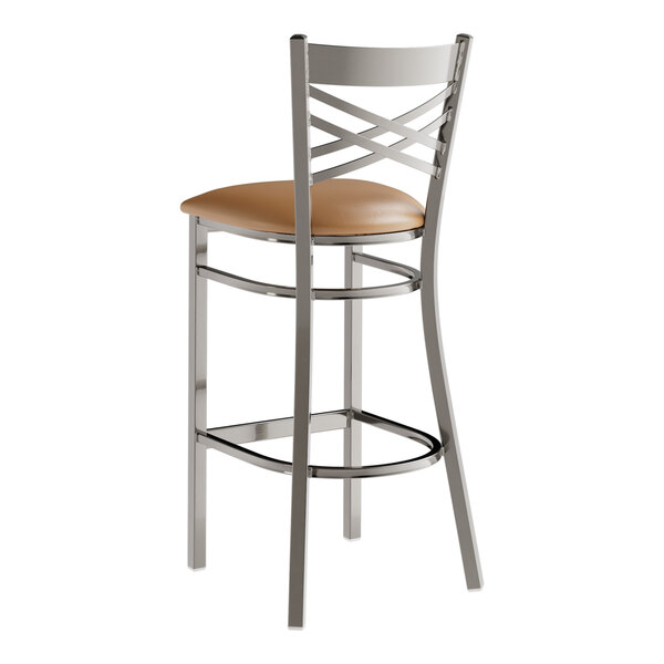A Lancaster Table & Seating metal bar stool with a light brown vinyl seat.