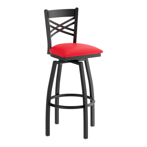 A black metal bar stool with a cross back design and a red vinyl padded seat.