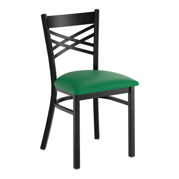 A black metal chair with a cross back design and a green vinyl padded seat.