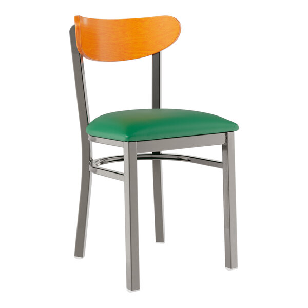 A Lancaster Table & Seating green vinyl chair with metal legs and a cherry wood back.