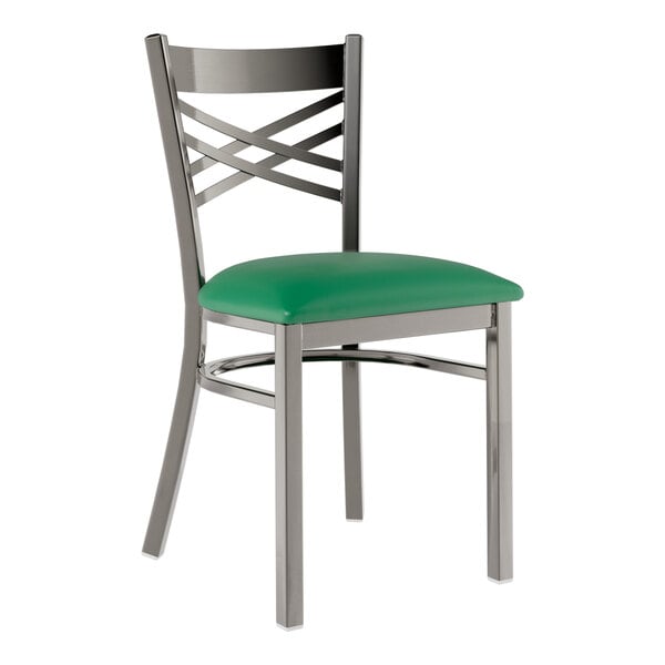 A Lancaster Table & Seating metal cross back chair with a green vinyl seat