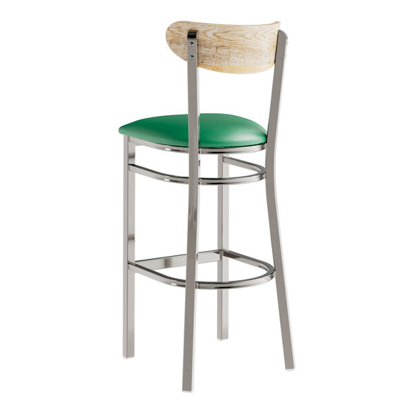 A Lancaster Table & Seating bar stool with a green vinyl seat and driftwood back on metal legs.