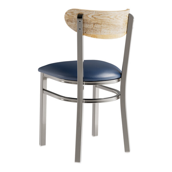 A Lancaster Table & Seating metal chair with a blue vinyl seat and driftwood back.