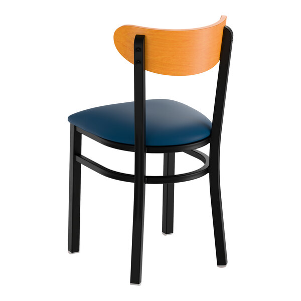 A black metal chair with a navy vinyl seat and a curved cherry wood backrest.
