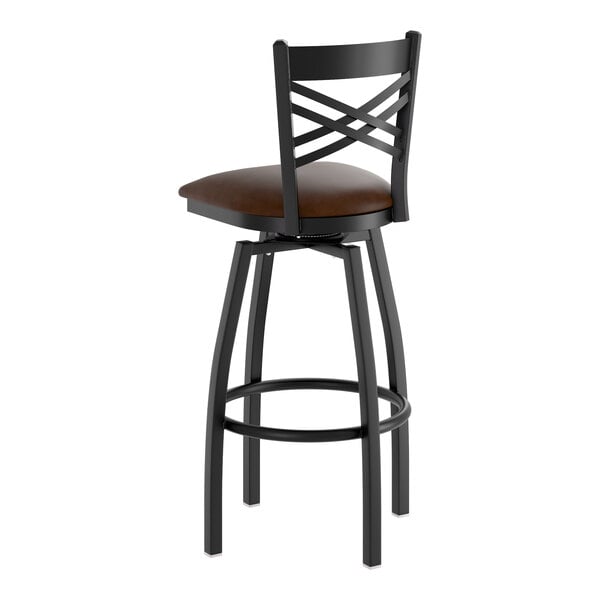 A black metal swivel bar stool with a cross back design and a dark brown vinyl padded seat.