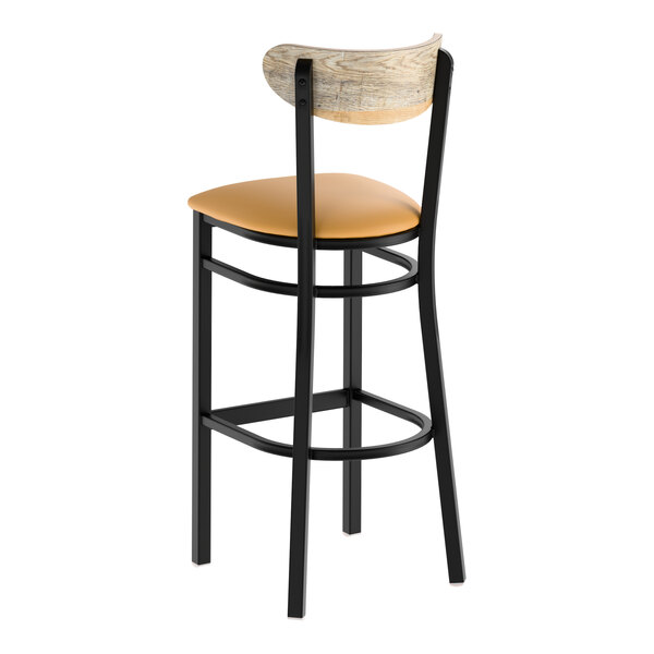 A bar stool with a black metal frame, light brown vinyl seat, and a driftwood-finished curved wooden backrest.