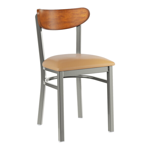 A Lancaster Table & Seating Boomerang chair with a tan cushioned seat and wood back.