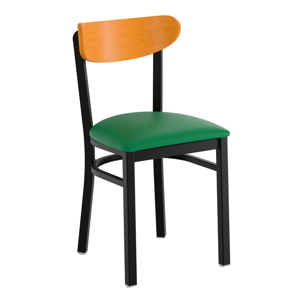 A black chair with a green vinyl seat and a cherry wood backrest.