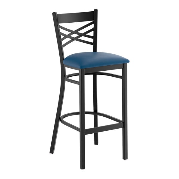 A black metal bar stool with a cross back design and a navy blue padded vinyl seat.