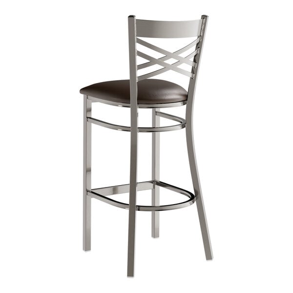 A Lancaster Table & Seating cross back bar stool with a dark brown leather seat.