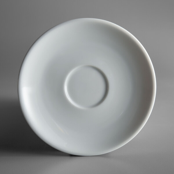 A Oneida Royale bright white porcelain saucer with a circle in the middle.