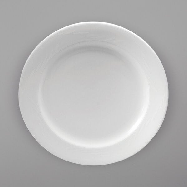 A Oneida Royale bright white porcelain plate with a white rim on a gray surface.