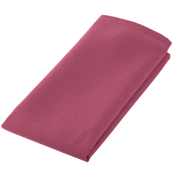 A folded mauve cloth napkin on a white background.