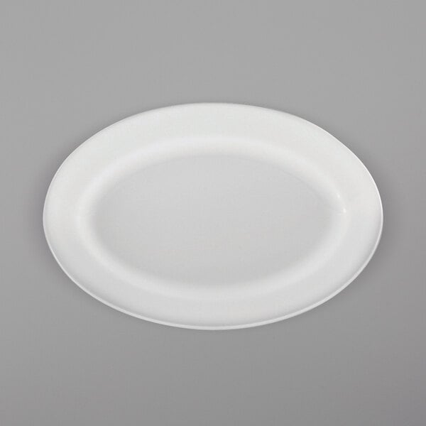 A white Oneida Royale porcelain oval platter with a white rim on a gray surface.