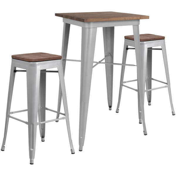 A Flash Furniture rustic galvanized steel and wood bar height table with metal legs and two backless stools.