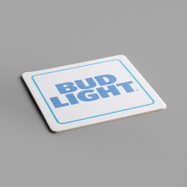 A close-up of a white square paper coaster with a blue logo that says "bud light"