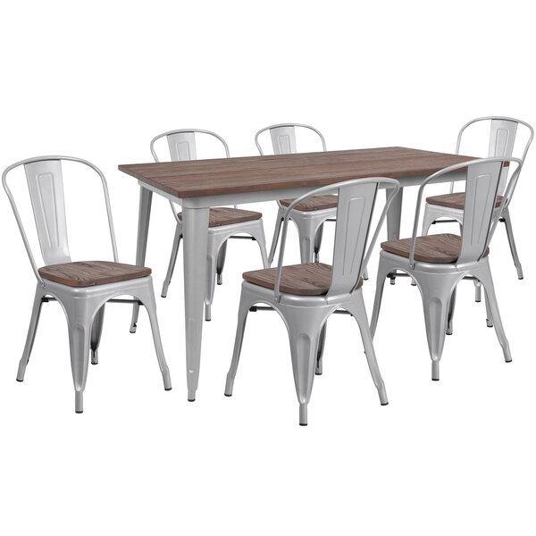 A Flash Furniture rustic galvanized steel and wood table with 6 chairs on an outdoor patio.